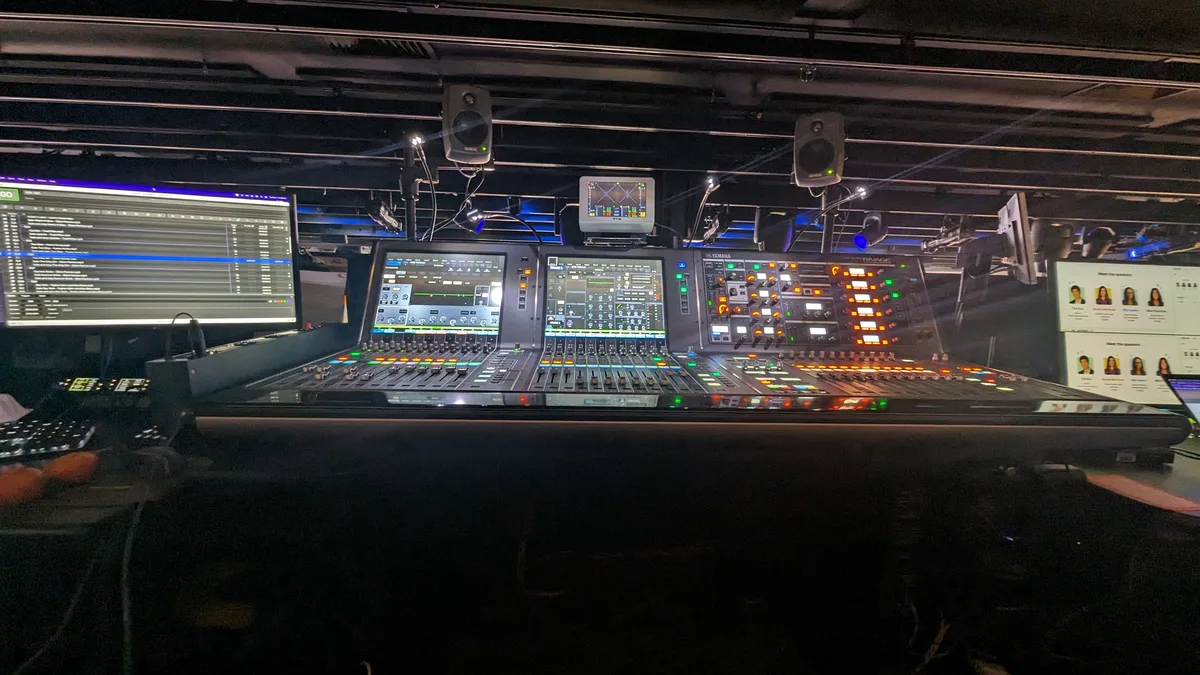 Digital console with touchscreens under a ceiling grid